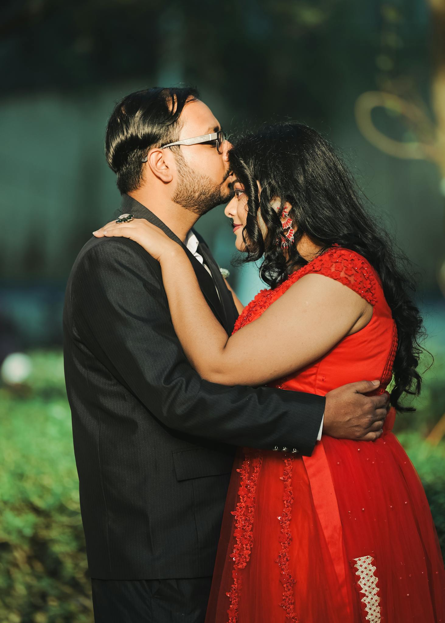 A couple in a loving embrace during a pre-wedding shoot outdoors in Kolkata, India.